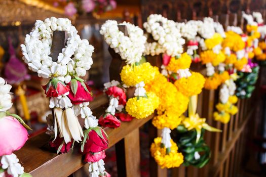 garlands hang on wood at Wat Pho (Phrachettuphon temple),Bangkok ,Thailand