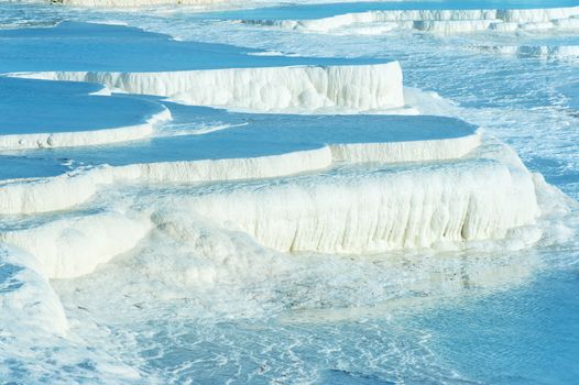 Blue pools and white travertine terraces at Pamukkale, Turkey 