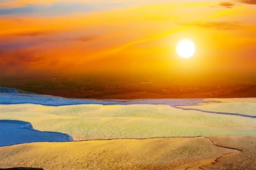 Beautiful vivid sunset over the travertine terraces and pools at Pamukkale, Turkey