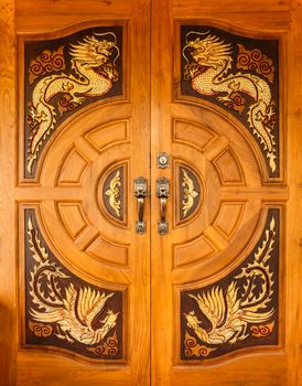 Wood door with dragons and swans design