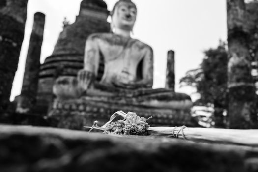 image of Buddha and dry flower in Sukhothai ,Thailand