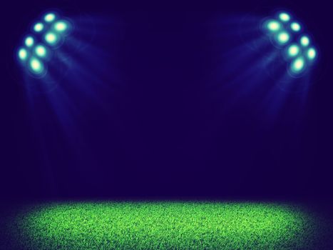 Spotlights illuminating area of green grass court in the dark