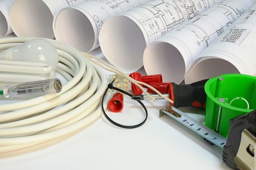 Drawing rolls, socket box, power cable, screwdriver and other tools on white surface