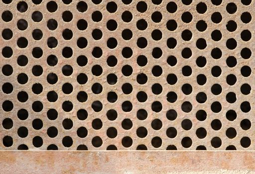 Texture of old rusty dirty grate with circle holes.