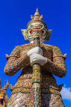 The statue of giant hold club and blue sky in Wat Phra Kaew ,Thailand (Ant's Eye View)