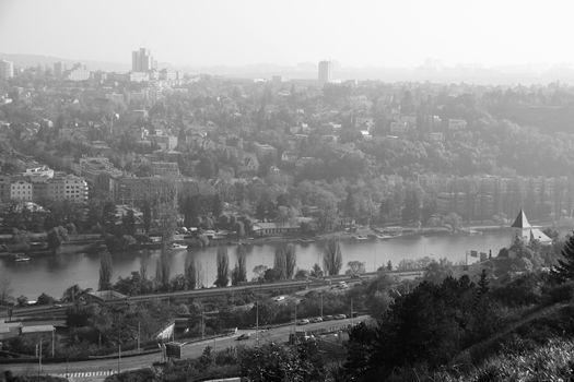 Photo shows a general city view with houses, trees and river.