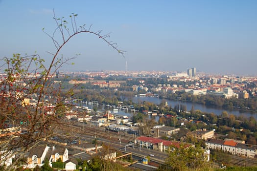 Photo shows a general city view with houses, trees and river.