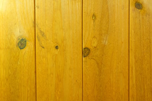 Photo shows a closeup of a wooden brown background texture.