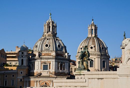 Photo shows Rome cityscape with houses and roofs.