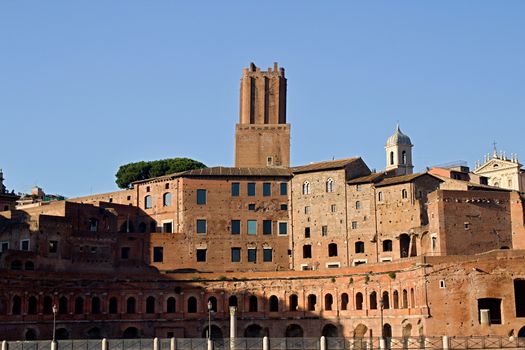 Photo shows Rome cityscape with houses and roofs.