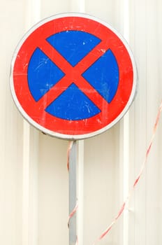 Old rusty blue and red traffic sign clearway on white background.