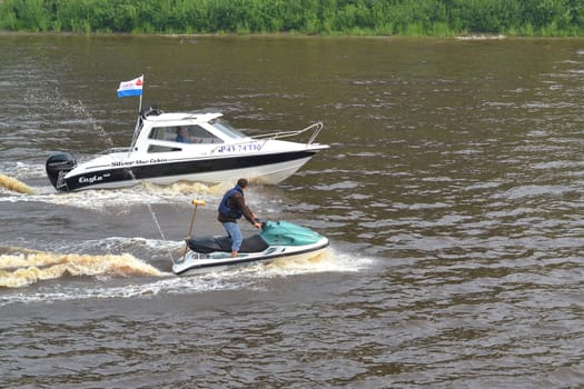 The man on a hydrocycle floats down the river