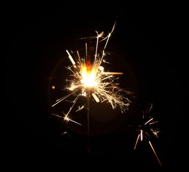 burning sparkler on a dark background