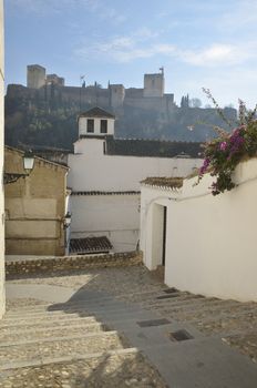 View of Alhambra from a street of the Albaycin, a district of Granada, in Andalusia, Spain.
