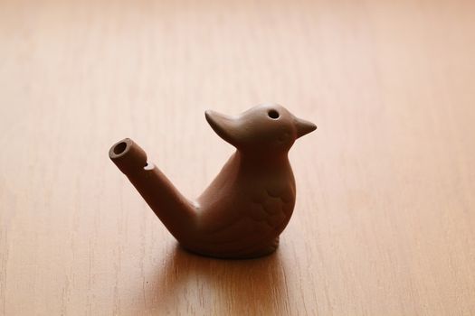 clay whistle in the bird shape on table