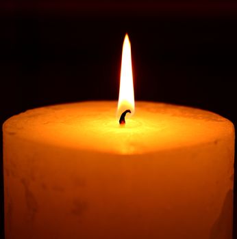 candle burning on a black background