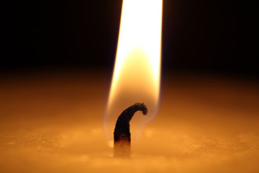 candle burning on a black background
