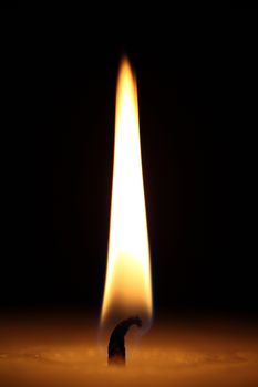 candle burning on a black background