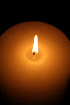 candle burning on a black background