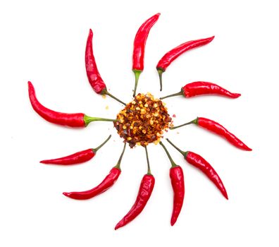 Hot peppers forming a sun on white background