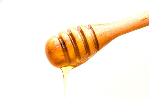 Spoon honey with honey on white background