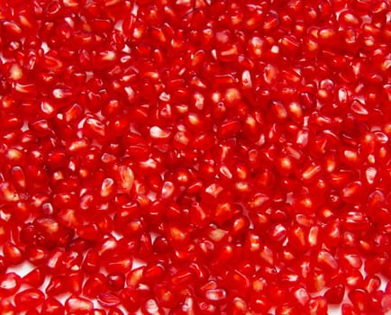 Pomegranate seeds on a white background.