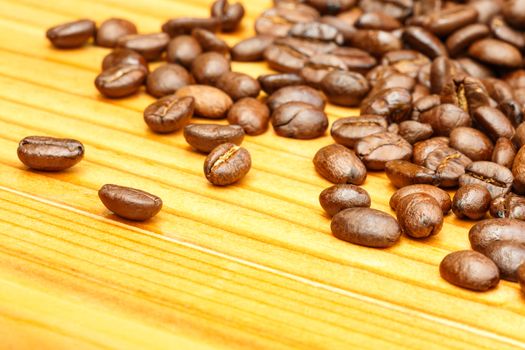 close up of coffee beans on wooden table