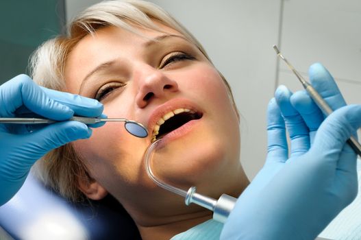 dentist at work with patient, dental exam and calcucus removal