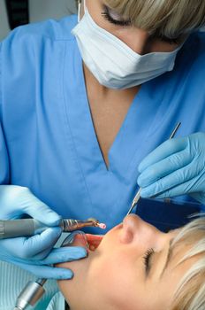 dentist at work with patient, dental exam, polishing and finishing