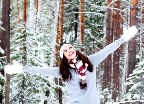 Happy woman in a winter forest.