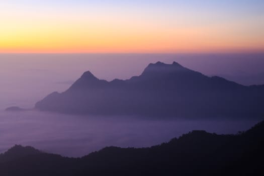 Sea of fog and mountain(silhouette) with sunrise in the morning at Phu Chi Fa ,Chiangrai, ,Thailand