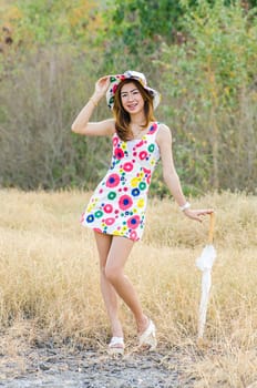 Portrait of charming woman on meadow, model is a asian girl.