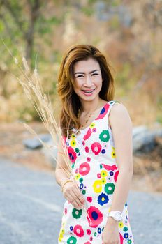 Portrait of charming woman on meadow, model is a asian girl.