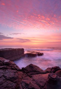 Sunrise with beautiful skies and ocean flows at the North Avoca rock shelf. Central Coast, Australia.    A beautiful morning to behold