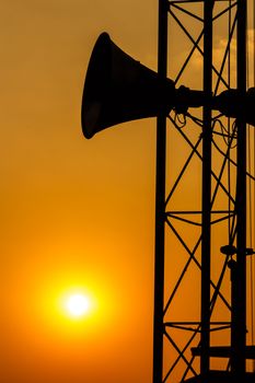 loudspeaker on pillar and sunset in the evening (silhouette) in Thailand