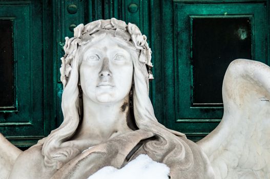 detail of a mourning sculpture on a cemetery