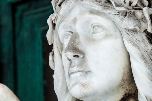 detail of a mourning sculpture on a cemetery