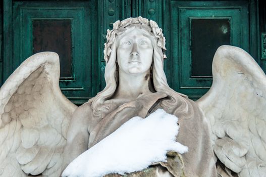 detail of a mourning sculpture on a cemetery