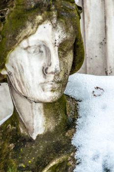 detail of a mourning sculpture on a cemetery