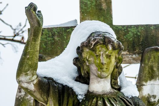 detail of a mourning sculpture on a cemetery