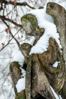 detail of a mourning sculpture on a cemetery