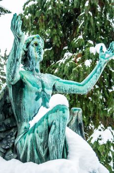 detail of a mourning sculpture on a cemetery