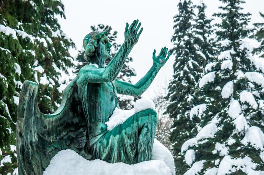 detail of a mourning sculpture on a cemetery