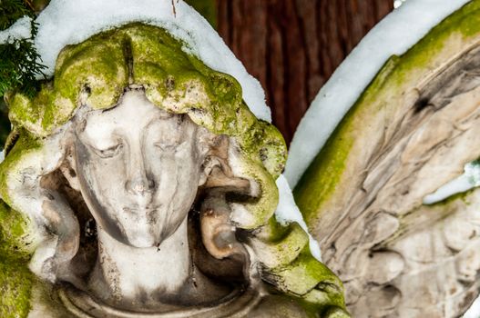 detail of a mourning sculpture on a cemetery