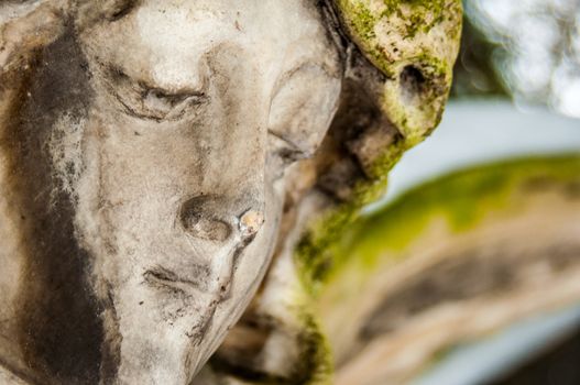 detail of a mourning sculpture on a cemetery