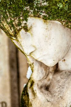 detail of a mourning sculpture on a cemetery