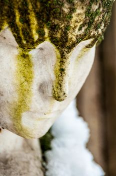 detail of a mourning sculpture on a cemetery