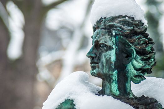 detail of a mourning sculpture on a cemetery