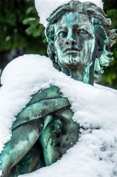 detail of a mourning sculpture on a cemetery