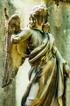 detail of a mourning sculpture on a cemetery